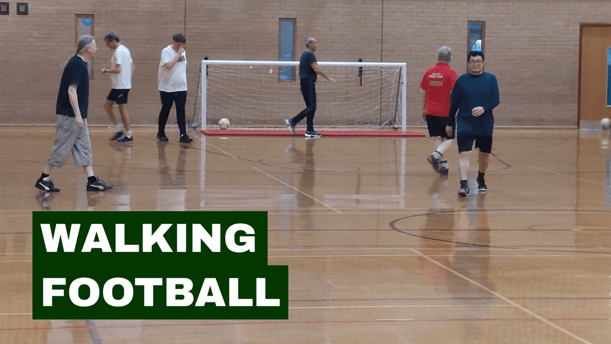 Participants playing walking football indoors at Step Out Stay Out’s Walking Football and Cuppa in Clifton.